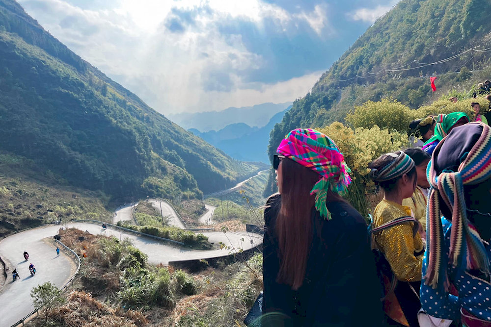 A breathtaking shot from the Ma Pi Leng Skywalk, showcasing the winding pass hugging the mountainside